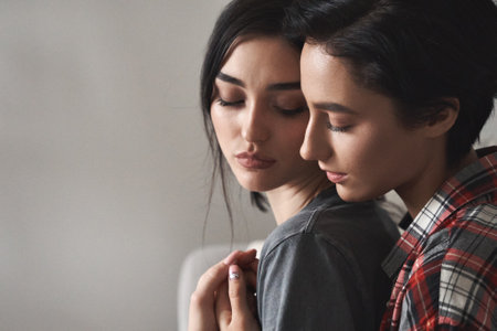 Sensual affectionate lesbian couple in love hugging together, close up portrait.の写真素材