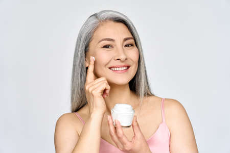 Happy middle aged mature asian woman headshot portrait. Rejuvenating skin care ads.の写真素材