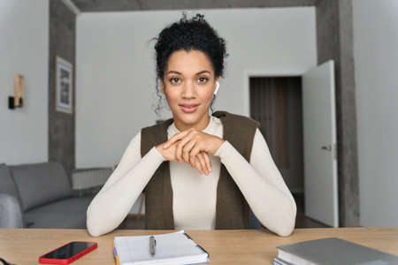 African American female manager having video call videoconference on laptop.の写真素材