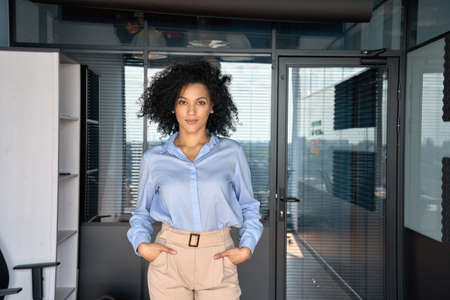 Portrait of stylish African American businesswoman manager in modern office.