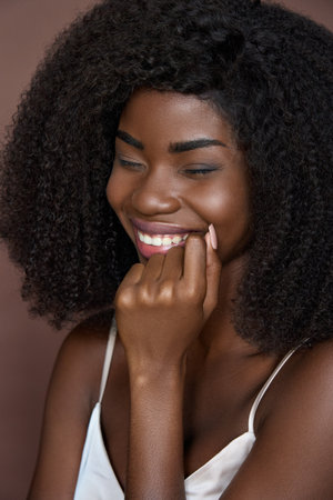 Closeup vertical portrait of young cheerful happy black girl. Beauty concept.の写真素材