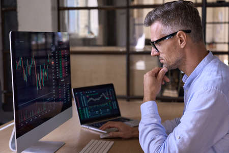 Crypto trader investor using computer cryptocurrency stock market trading chart.の写真素材