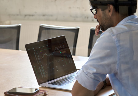 Indian business man analyzing stock market crypto trading chart.の写真素材