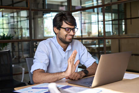 Indian manager, teacher or coach leading virtual video call meeting.の写真素材