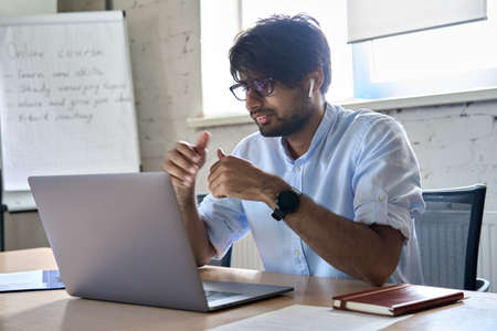 Indian manager, teacher or coach leading virtual video call meeting.