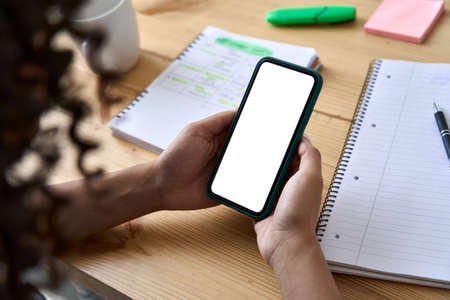 African American college girl student using phone with mock up screen.