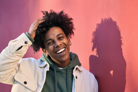 Young happy African American teen guy smiling outdoors, portrait.の写真素材
