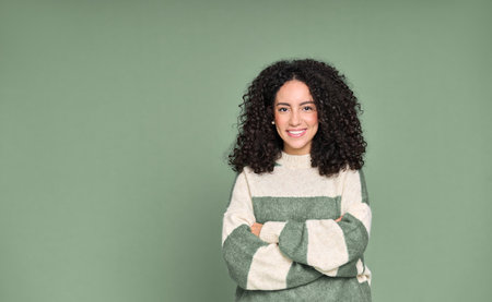 Young happy latin woman student standing isolated on green background, portrait.の写真素材