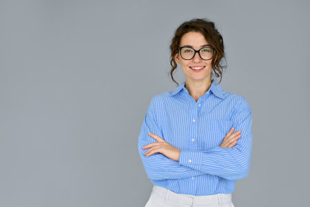 Smiling young confident professional business woman at gray background portrait.の写真素材