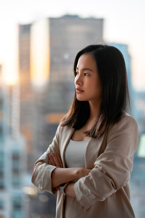 Young confident Asian business woman executive looking at window thinking.の写真素材