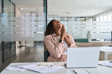 Euphoric business woman celebrating good financial work result in office.の写真素材