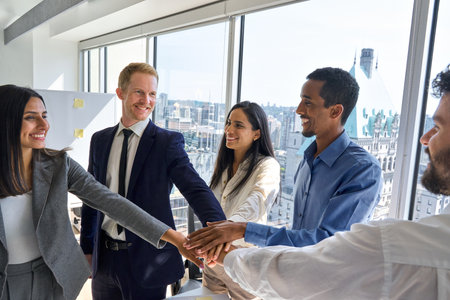 International business team people joining hands together in stack in office.