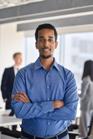 Confident African American business man standing in office, vertical portrait.の写真素材