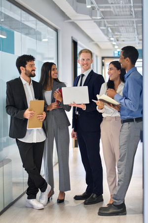 5 diverse happy professional team business people standing in office hallway.