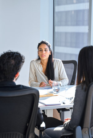 Busy professional latin business woman working at in board meeting. Vertical