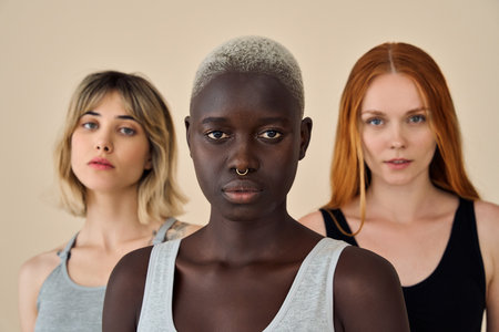Cool gen z Black blonde girl with diverse models on background, beauty portrait.の写真素材