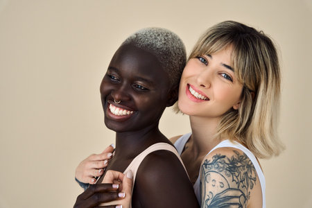 Happy gen z girls beauty models faces on beige background, close up portrait.