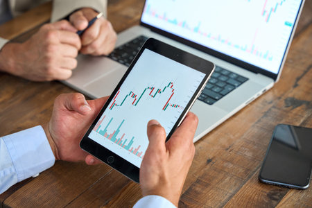 Advisor consulting stock market investor analyzing investment plan on tablet.の写真素材