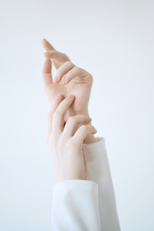 Close up vertical photo of two hands of woman isolated on white background.の写真素材