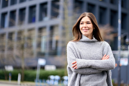 Young smiling professional business woman standing on street, portrait.の写真素材