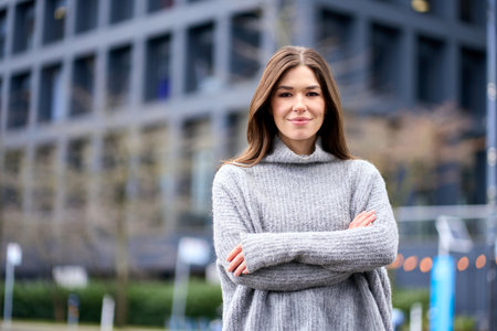 Young smiling professional business woman standing on street, portrait.の写真素材