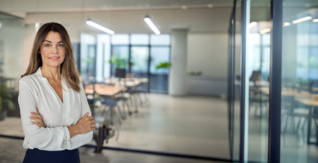 Smiling confident Latin professional mature business woman in office, portrait.の写真素材