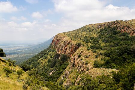 A small ridge with hikers checking the view within the Magaliesberg Mountain rangeの写真素材