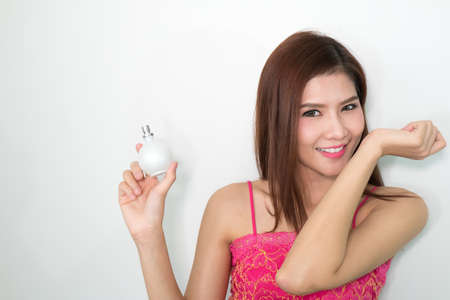 beautiful woman applying perfume on her bodyの写真素材