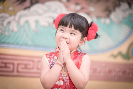 Cute girl wearing red Chinese suit,Photos provided by background ambience China .の写真素材