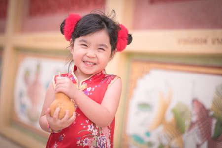 Asian Chinese girl in Traditional Chinese hold calabash,Photos provided by background ambience China .の写真素材