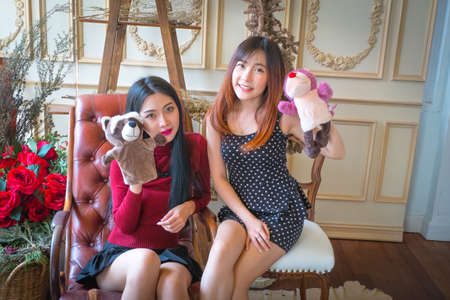 Two cute girl and Playing with Sock Puppets On a bright day.の写真素材