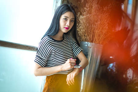 Youth and technology. Amazed young woman with smartwatch using stylus on touch screen.の写真素材