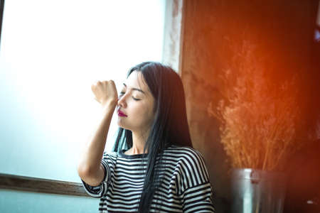 The little girl is smelling the perfume on your wrist.の写真素材
