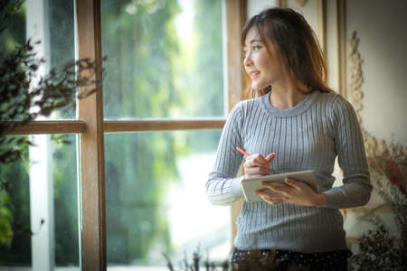 Girl texting on the tablet computer ,With space for text ads.の写真素材