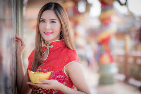 Asian Chinese woman in Traditional Chinese  hold Chinese moneyの写真素材