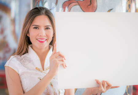 Asian Chinese woman in Traditional Chinese hold empty blank boardの写真素材