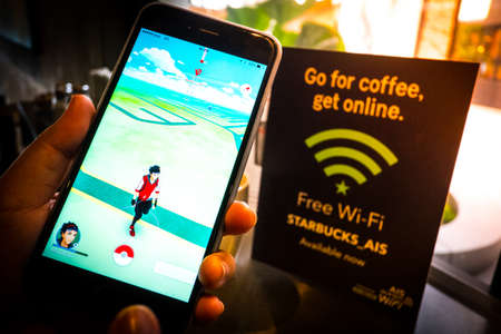BANGKOK, THAILAND - August 12,2016: Pokemon Go gameplay screenshot on the phone. Pokemon Go is a location-based augmented reality mobile game,Playing in cafe,free wifiのeditorial素材