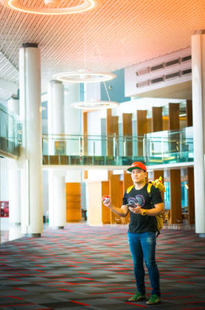 BANGKOK, THAILAND  - August 14,2016:  Trainer boy playing pokemon , pokemon ball playing at Gym Pokemon location ,Lighting with sun flare,のeditorial素材