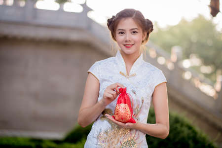 Asian Chinese woman in Traditional Chinese hold Gift Bag