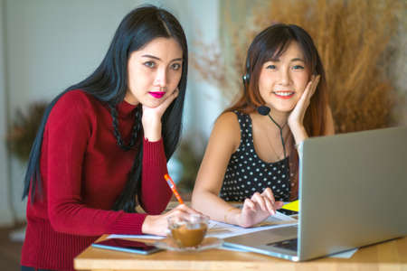 2 Female customer support operator with headset and smilingの写真素材