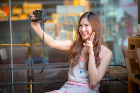 Travel tourist woman on vacation,And taking pictures from the cameraの写真素材