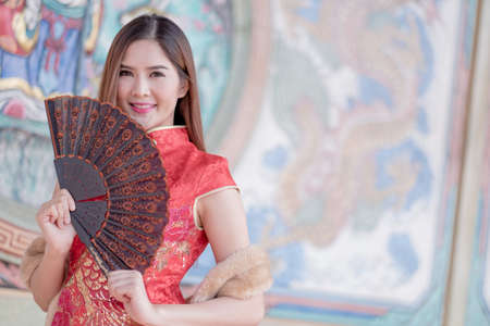 Asian Chinese woman in Traditional Chinese holding blowの写真素材