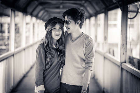 Couple hugging each other on the bridge in comfort.The black and white photography.の写真素材