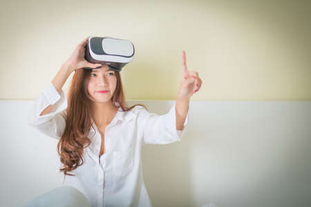 vr box, Asian Woman looking though VR device ,Lighting with sun flareの写真素材