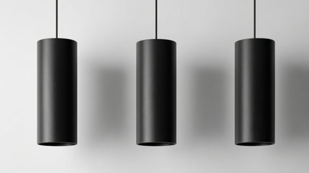 Black metal hanging lights with simple cylindrical shapes, isolated on white, professional lookの素材
