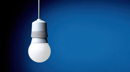 Modern LED bulb glowing brightly against shadowy background, idea and technology themeの素材