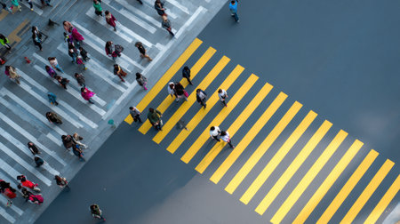 A bustling scene of pedestrians navigating a vibrant urban crosswalk showcasing city life.の素材