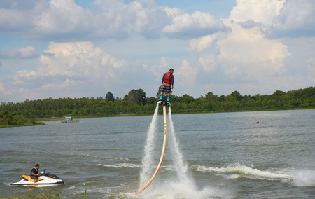 YASOTHON, THAILAND - JUNE 19, 2016: Man ride on flyboard; an extreme water sport at public park.のeditorial素材