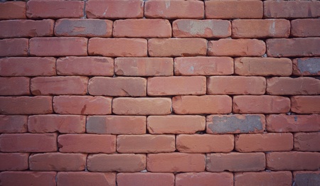 Red brick wall texture in vintage style with corner vignette. Narrow block gaps and hidden mortar....