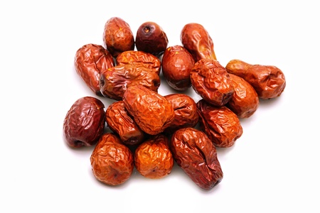 Dried red jujube on white background. Herbal fruit and good for health, traditional Chinese medicine. Use as visual content about this fruit.の写真素材